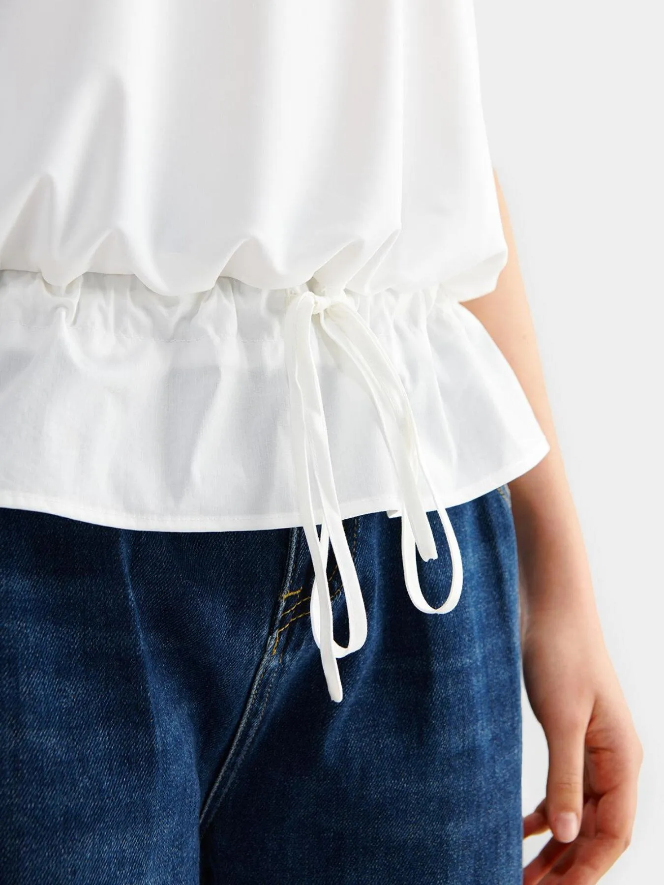 Drawstring Tie Front Ruffle Hem Top